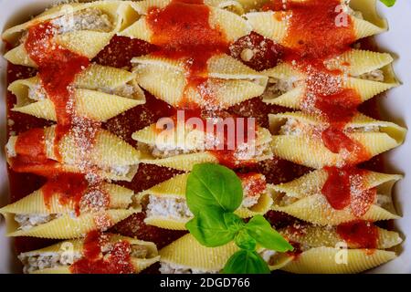 Jumbo shells pasta stuffed with meat, ricotta, tomato sauce. Stock Photo