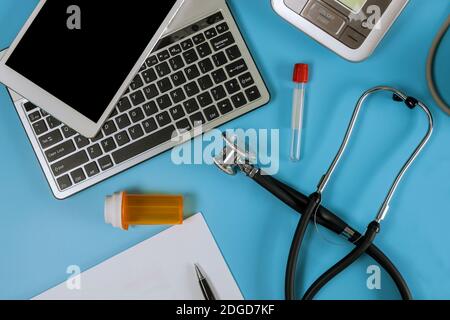 Modern electric tonometer and a stethoscope on a computer keyboard blood pressure monitor Stock Photo