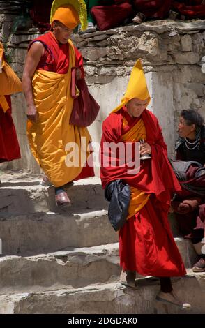 Yellow hat Buddhist Lama in monastic attire and bell , Karsha monastery, near Padum Zanskar Valley, Ladakh, Jammu and Kashmir, northern India Stock Photo