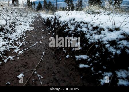 Mud and fresh fallen snow on a trail. Stock Photo