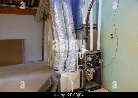 New home construction with installation of heating system in basement Stock Photo