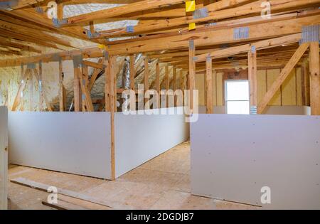 Inside attic roof andwall insulation in wooden house, building under construction Stock Photo