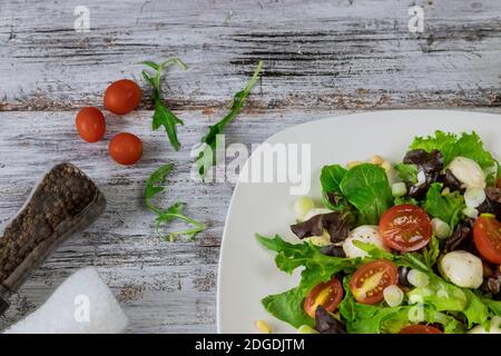 Green salad made with spinach, cheese mozzarella balls. Stock Photo