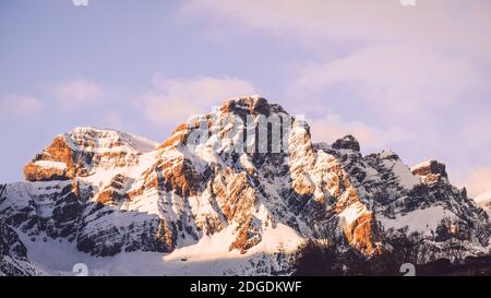 Low angle view panorama of snowcapped mountains against dramatic sky during sunrise in Panticosa, Spain Stock Photo