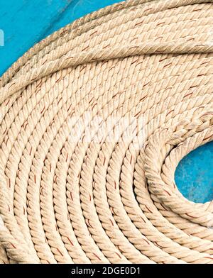 Light braided rope part of marine fasteners, folded in a circle close-up, empty space in the middle Stock Photo