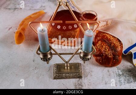 Sabbath Jewish Holiday challah bread and candelas on wooden table Stock Photo
