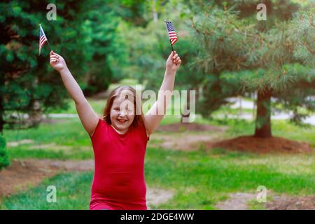 Funny little girl with waving american flag. Independence Day, Flag Day Stock Photo