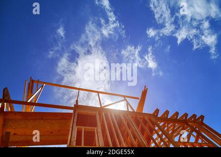 New construction home framing against blue sky, Stock Photo