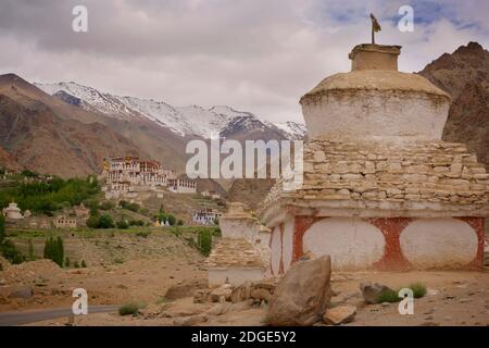 Likir monastery set amongst irrigated fields with mountain peaks beyond. Likir, Ladakh, Jammu and Kashmir, India Stock Photo