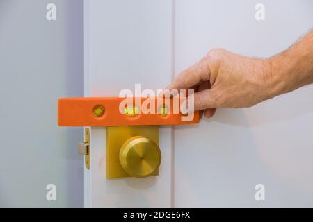 Male carpenter fixing lock in door with home Stock Photo
