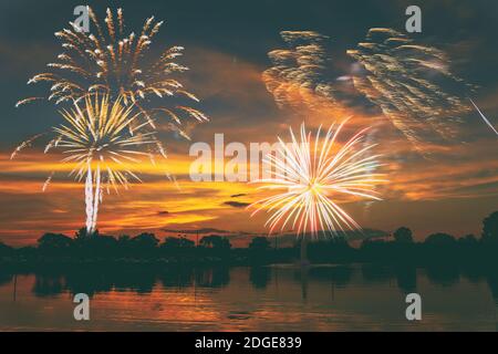 Fireworks display on majestic beautiful sunset sky lake s Stock Photo