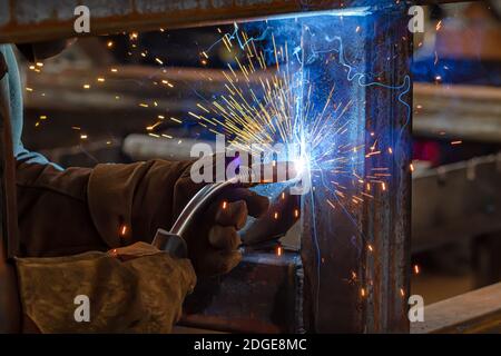 Semi-automatic welding with sparks and smoke Stock Photo