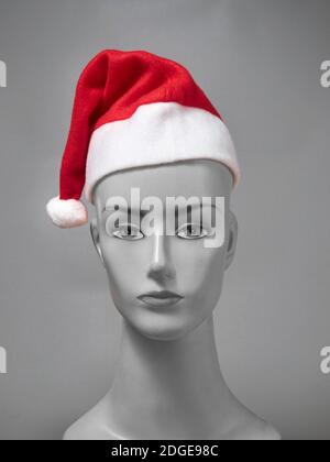 Front view of Santa Claus hat stock image on grey background for Christmas occasion Stock Photo