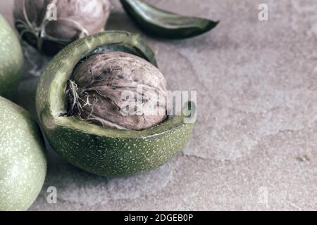 Walnuts in a green shell on the table Stock Photo
