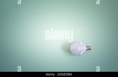 Electric energy-saving lamp on a light background. Stock Photo