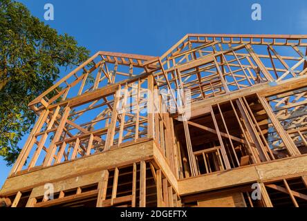 New construction home framing against a blue sky Stock Photo