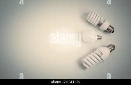 Electric energy-saving lamps on a light background. Stock Photo
