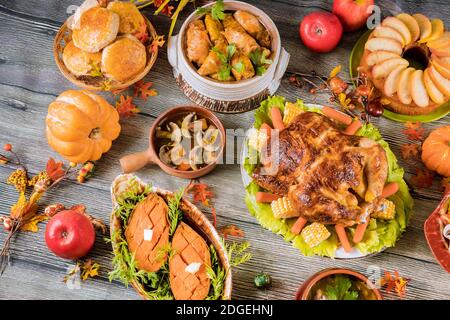Roasted turkey garnished with many dishes on the table. Thanksgiving Day. Stock Photo