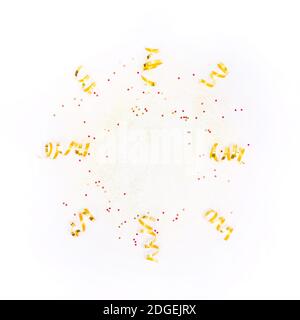 Isolated round frame with golden decorations, confetti, sparkles on white background. Christmas, party, wedding, birthday. Flay lay with copy space Stock Photo