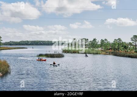 Kayaking and paddleboarding on Western Lake, a coastal dune lake in Grayton Beach State Park, in the Florida panhandle county of South Walton, USA. Stock Photo