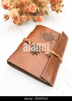 Dried flowers and a leather notebook Stock Photo