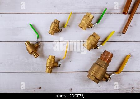 Plumbing gate ball vales, flexible water hose and fittings on a connecting pipe water Stock Photo