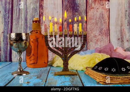 Menorah With Burning Candles For Hanukkah Celebration On Table Against 