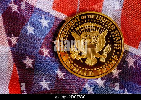 Presiden Donald Trump coin against US flag background in the election 2020 Stock Photo