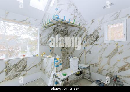 Construction work installing ceramic tile on reconstruction of bathroom Stock Photo