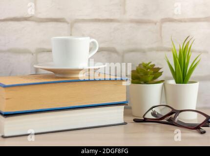 A small Cup of morning coffee and a book on the table. Stock Photo