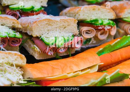 Sandwiches with vegetables and ham sold in fast food restaurant. Stock Photo