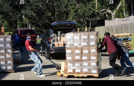 Palm Bay, United States. 08th Dec, 2020. Volunteers move boxes of food at the Share Your Christmas food distribution event sponsored by the Second Harvest Food Bank of Central Florida, Hands for Healing, and WESH 2 at Eastwind Pentecostal Church. Central Florida food banks continue to struggle to meet demand amid the COVID-19 pandemic. Credit: SOPA Images Limited/Alamy Live News Stock Photo