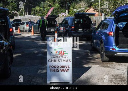 Palm Bay, United States. 08th Dec, 2020. People line up in their cars to receive food at the Share Your Christmas food distribution event sponsored by the Second Harvest Food Bank of Central Florida, Hands for Healing, and WESH 2 at Eastwind Pentecostal Church. Central Florida food banks continue to struggle to meet demand amid the COVID-19 pandemic. Credit: SOPA Images Limited/Alamy Live News Stock Photo