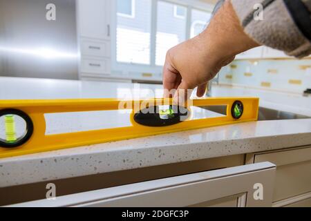 Leveling with countertops of making a modern domestic kitchen cabinets Stock Photo