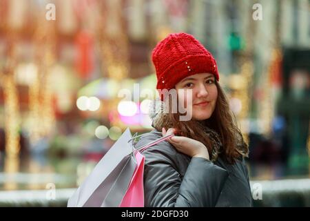 Young girl going holding shopping bags Stock Photo