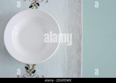 A white empty plate on a linen napkin Stock Photo