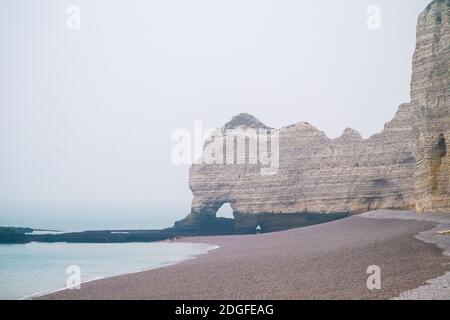 Misty morning fog landscape on the cliffs of Etretat in France Stock Photo