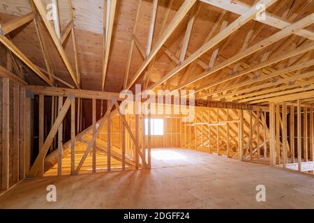 Interior of attic room with under reconstruction installing wooden frame for improvement Stock Photo