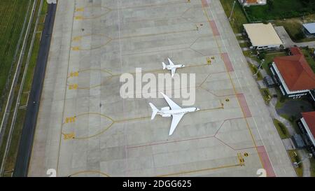 Aerial view to international airport with airplane. Due to Corona grounded Airplanes waiting on Denpasar Airbase, Bali, Indonesia Stock Photo