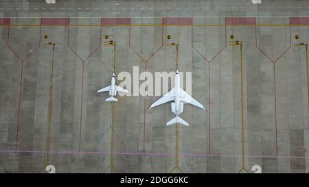 Aerial view to international airport with airplane. Due to Corona grounded Airplanes waiting on Denpasar Airbase, Bali, Indonesia Stock Photo