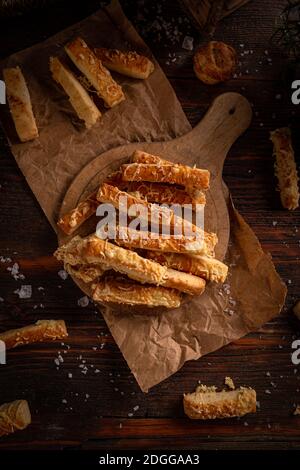 Homemade crunchy cheese straws on rustic background composition, top view Stock Photo