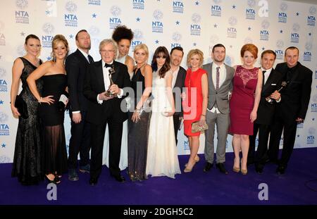 Cast and crew from Coronation Street including Willam Roache, Natalie Gumede, Michelle Collins, Paula Lane, Jane Danson, Ian Puleston-Davies and Jennie McApline with their Best Serial Drama Award, in the press room at the 2013 National Television Awards at the O2 Arena, London. Stock Photo