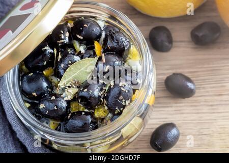 Pickled olives in a glass jar with a lid. Stock Photo