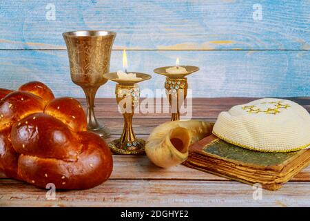 Shabbat challah bread, shabbat wine and candles on the table Stock Photo