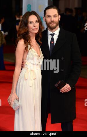 Kelly Marcel and Tom Hardy arriving at The EE British Academy Film Awards 2014, at the Royal Opera House, Bow Street, London.   Stock Photo