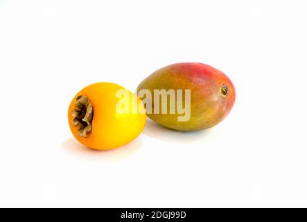 Fresh raw, red and green tropical fruit mango concept. Close-up on a white isolated background. Stock Photo