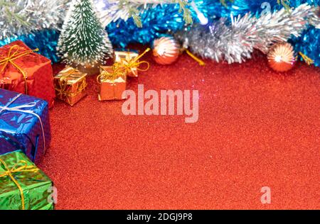 New year's and Christmas decoration in Red background, gift boxes and pine cones. Stock Photo