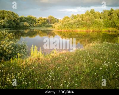 Landscape with a stormy sky at sunset. Stock Photo