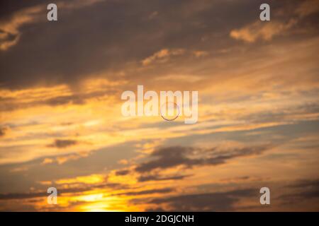 Single soap bubble flying at the dramatic cloudy sunset sky. Stock Photo