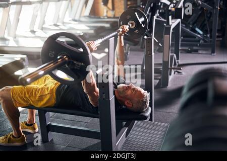 Bodybuilder lying on his back during the bench press Stock Photo